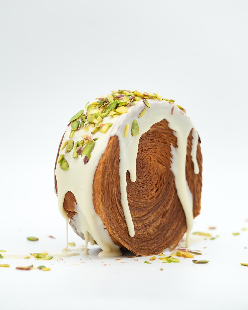 Roll croissant with white chocolate and chopped pistachios