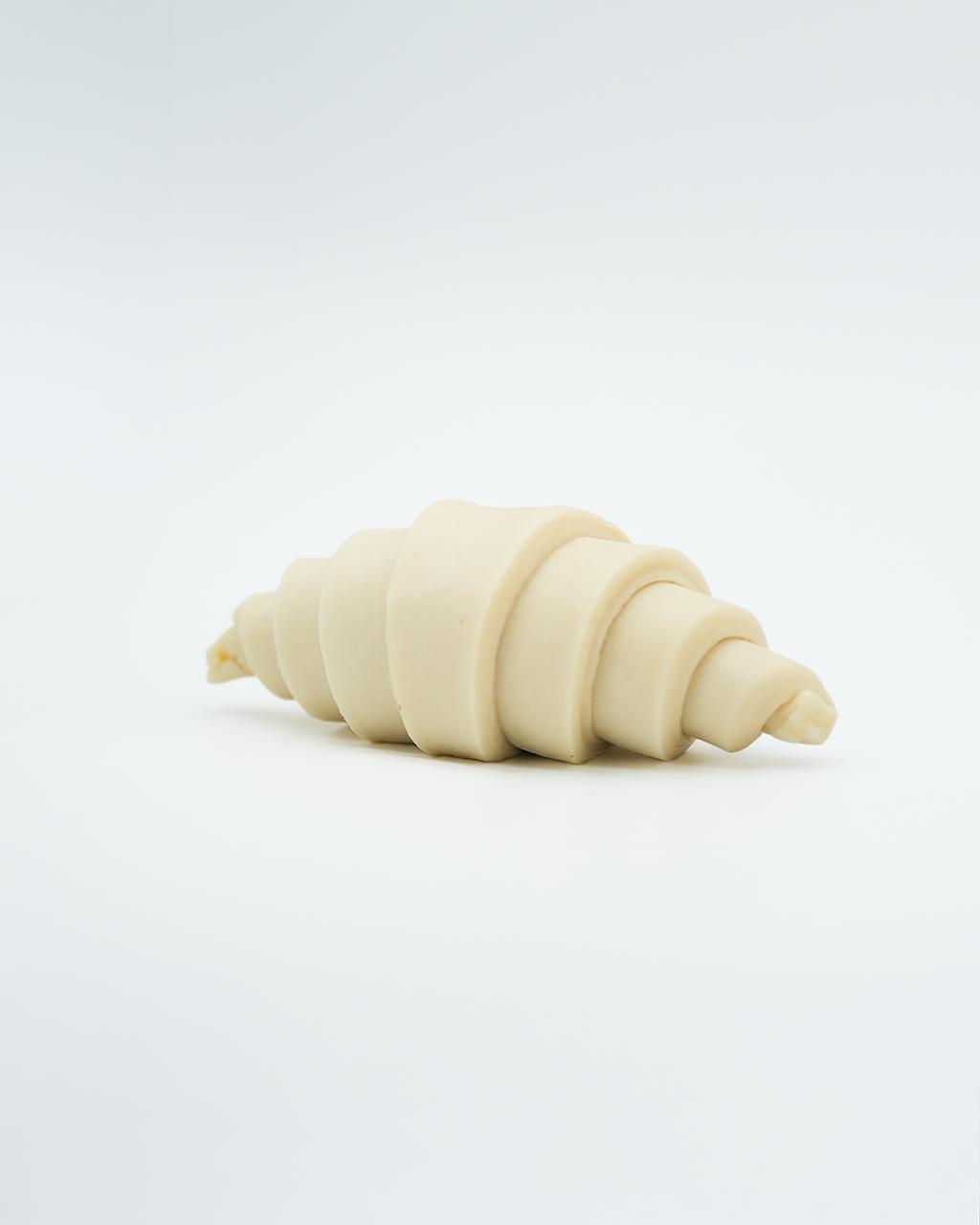 Rolled, unbaked croissant dough
