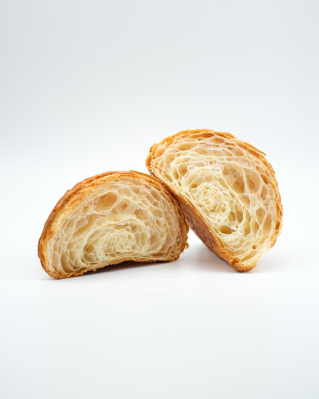 Butter croissant cut in half, showing its layers